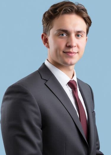 Professional headshot of a man in a gray suit and tie, ERAS photo example